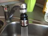 A close-up of a faucet attachment in a kitchen sink. Produktbild-Vorschau