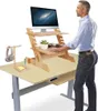 A man stands at a standing desk with a computer and accessories. Produktbild-Vorschau