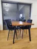 A dining table with four chairs in a room with large sliding glass doors and blinds. Anteprima dell’immagine prodotto