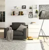 A modern living room setting with a chair, shelves, and a chest of drawers. Produktbild-Vorschau