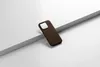A brown iPhone case is placed on a white surface with a gray diagonal element. Produktbild-Vorschau
