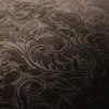 A close-up view of a dark brown fabric with an embossed floral pattern. Podgląd zdjęcia produktu