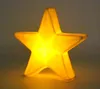 A lit-up yellow star-shaped lamp. Produktbild-Vorschau