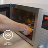 A person is placing an item into a microwave. Anteprima dell’immagine prodotto