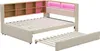 A beige upholstered bed frame with a wooden headboard featuring shelves and LED lighting, and a pull-out trundle bed. Náhled obrázku produktu