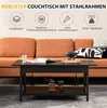 A black coffee table is shown in front of an orange sofa, with decorative items on it and in the background. Náhľad obrázku produktu