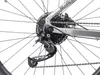 A close-up view of the rear derailleur and cassette of a bicycle. Produktbild-Vorschau