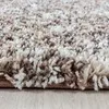 A close-up view of a shaggy rug with a textured, mottled design. Podgląd zdjęcia produktu