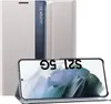 A silver flip case for a Samsung Galaxy S21 FE 5G phone is shown with the phone inside, displaying the screen. Voir les images du produit