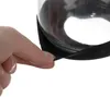 A hand is shown pressing on the rubber seal of a glass coffee grinder. Náhľad obrázku produktu