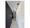 A modern hallway with a dark wall, white marble floor, and sheer white curtains. Produktbild-Vorschau