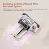 A close-up marketing image of a white and black mite vacuum cleaner with rose gold accents, shown at an angle with stylized purple light rays and green leaves emanating from it. Náhľad obrázku produktu