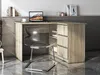 A corner desk with a laptop and a chair in a modern office setting. Produktbild-Vorschau