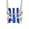 A baby swing seat with blue and white stripes, made of fabric and wood, suspended by ropes against a white background. Produktbild-Vorschau