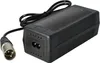 A black e-bike battery charger with a silver connector is shown against a white background. Produktbild-Vorschau