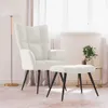 A cream-colored armchair and ottoman are placed in a room with sheer curtains and a floor lamp. Náhled obrázku produktu