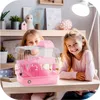 Two young girls are sitting at a desk with a pink hamster cage. Náhľad obrázku produktu