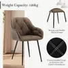 A brown upholstered chair with black metal legs, shown in a studio setting with decorative elements and close-up views of its construction. Produktbild-Vorschau