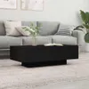 A black coffee table is placed in front of a gray sofa in a living room setting. Voir les images du produit