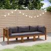 An outdoor sofa on a patio with a wooden fence and string lights in the background. Náhled obrázku produktu