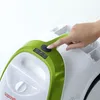 A hand is pressing a button on a green and white steam cleaner. Anteprima dell’immagine prodotto