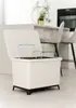 A white trash bin with a lid open, showing internal dividers, placed in a modern kitchen setting with bar stools and a counter in the background. Náhľad obrázku produktu