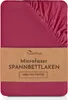 A folded pink fitted sheet with a brown label wrapped around it. Produktbild-Vorschau
