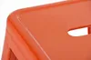 A close-up view of the corner of an orange metal bar stool. Náhľad obrázku produktu