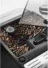 A close-up view of the bean hopper of a coffee machine, filled with coffee beans. Anteprima dell’immagine prodotto