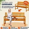 A woman is sitting on a wooden garden bench with a table that folds out from the center. The bench is shown in two configurations: one with the table folded away and one with the table extended. Text overlays describe the product's features. Anteprima dell’immagine prodotto