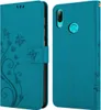A teal flip phone case with a floral and butterfly design is shown open and closed. Náhled obrázku produktu