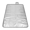 A silver picnic blanket with a black border and a small black loop at the top, laid flat on a white background. Produktbild-Vorschau