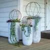 Three planters with LED light spheres on a wooden deck in front of a white building. Produktbild-Vorschau
