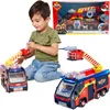 A young boy is playing with two toy fire trucks, one in the foreground and one in the background. The packaging for the fire truck is also visible in the upper right corner. Produktbild-Vorschau