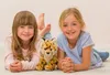Two young girls lying on the floor with a stuffed cheetah toy. Anteprima dell’immagine prodotto