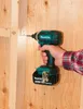 A person is using a Makita impact driver to screw into a wooden structure. Produktbild-Vorschau