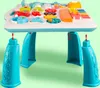 A close-up, slightly angled view of a baby activity table with its legs attached. The table is filled with various colorful toys and interactive elements. Podgląd zdjęcia produktu