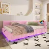 A pink upholstered daybed with LED lighting underneath, set up in a bedroom with decorative items on shelves and artwork on the wall. Náhled obrázku produktu