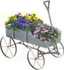 A wooden wagon planter filled with yellow and purple pansies and pink flowers, set against a white background. Voir les images du produit