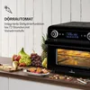 A black oven with a display screen and a rack inside, surrounded by fresh fruits and dried fruits on a countertop. Produktbild-Vorschau
