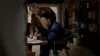 An older man is showing something on a piece of paper to a younger man in what appears to be a workshop or storage area. Anteprima dell’immagine prodotto
