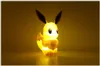 A lit-up Eevee figurine against a yellow gradient background. Náhľad obrázku produktu