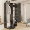 A modern graphite wardrobe with open doors, revealing shelves, a hanging rod with a sweater, and folded towels. Shoes are neatly arranged on the lower shelves. The wardrobe is positioned in a room with a door and a chair in the background. Voir les images du produit