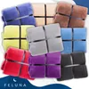 A collage of multiple folded blankets in various colors, each tied with a black ribbon. Produktbild-Vorschau