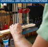 A person is using a drill press to drill a hole in a piece of wood. Produktbild-Vorschau
