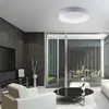A modern living room with a ceiling lamp, furniture, and a view of an outdoor patio. Produktbild-Vorschau