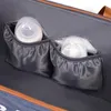 Close-up view of the interior of a diaper bag, showing two insulated pockets designed to hold baby bottles. Náhľad obrázku produktu