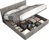 A bed with its storage compartment open, revealing various items stored inside. Anteprima dell’immagine prodotto