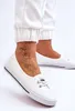 A close-up shot of a person's feet wearing white sneakers. Voir les images du produit