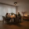 A family is having dinner at a table with candles lit. Náhľad obrázku produktu